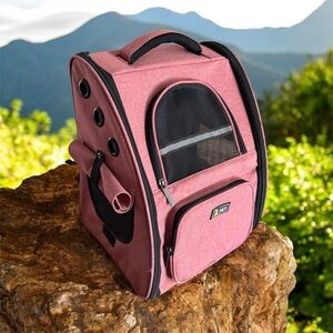Pet carrier backpack for cats and small dogs with many ventilation holes.